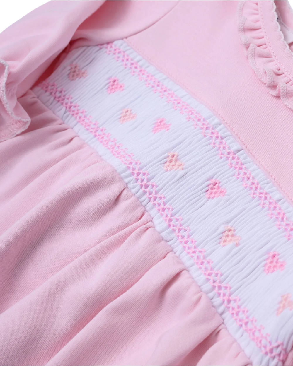 Close-up of a pink garment with decorative trim
