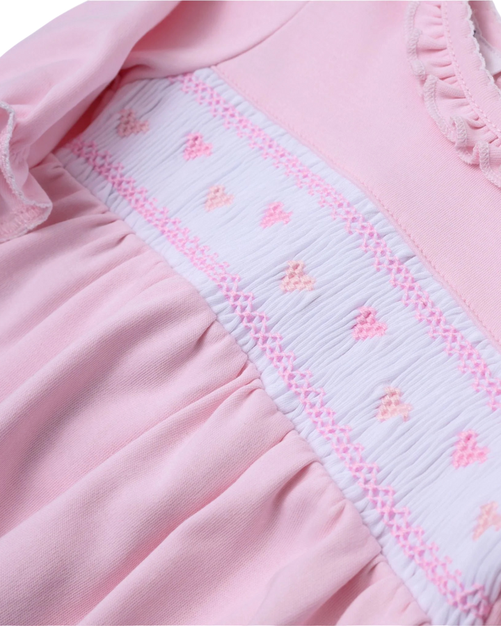 Close-up of a pink garment with decorative trim
