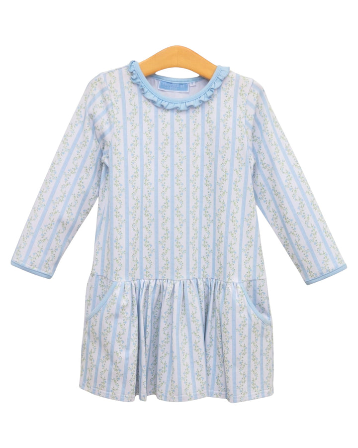 A light blue and white vertically striped long-sleeve baby dress with a ruffled collar, displayed on a wooden hanger against a white background, that store