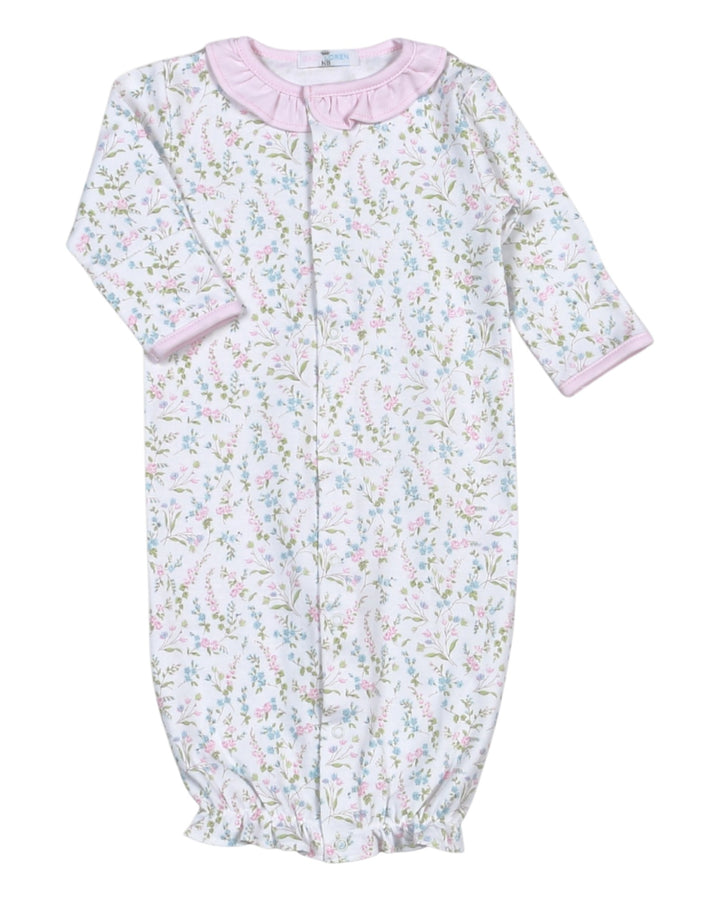 Baby onesie with floral pattern and pink trim on a white background