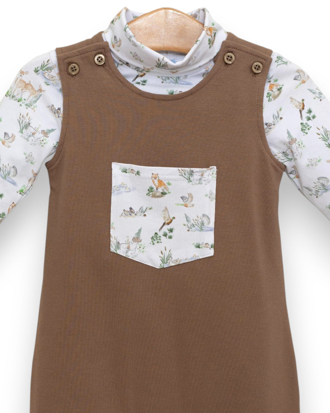 Brown dress with a patterned pocket and floral long-sleeve shirt underneath on a white background