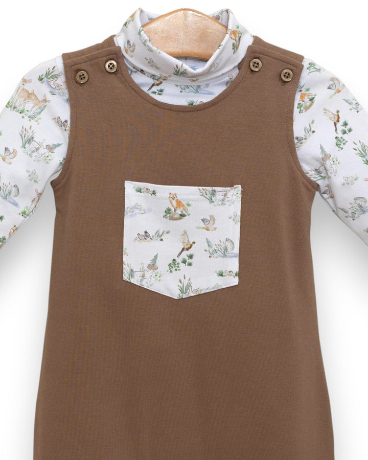 Brown dress with a patterned pocket and floral long-sleeve shirt underneath on a white background