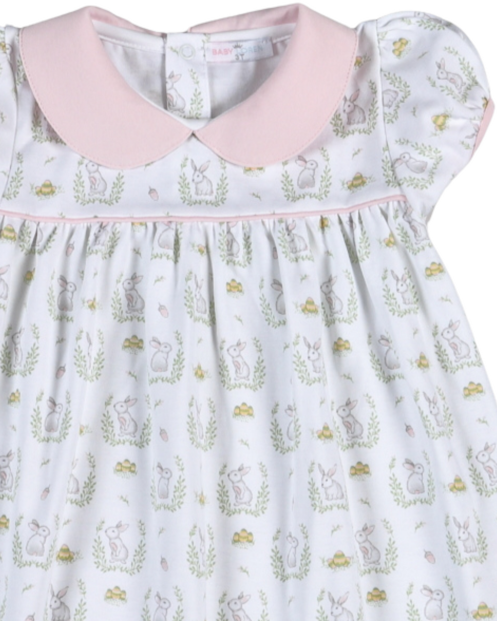 Children's dress with pink collar and animal print on a light blue background