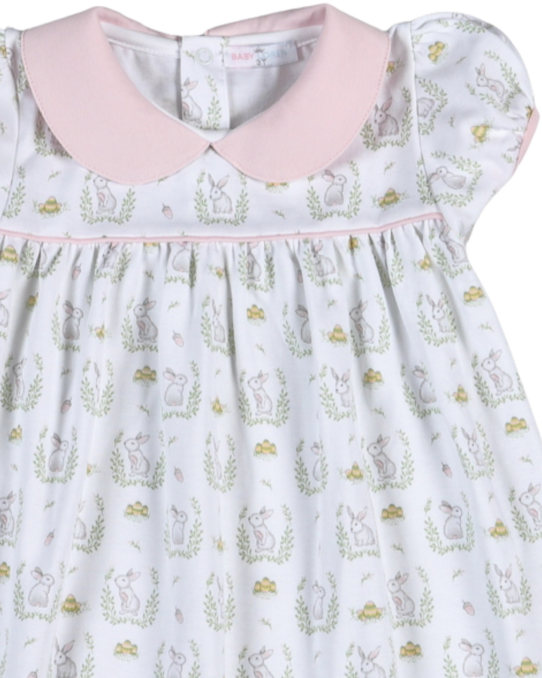 Children's dress with pink collar and animal print on a light blue background
