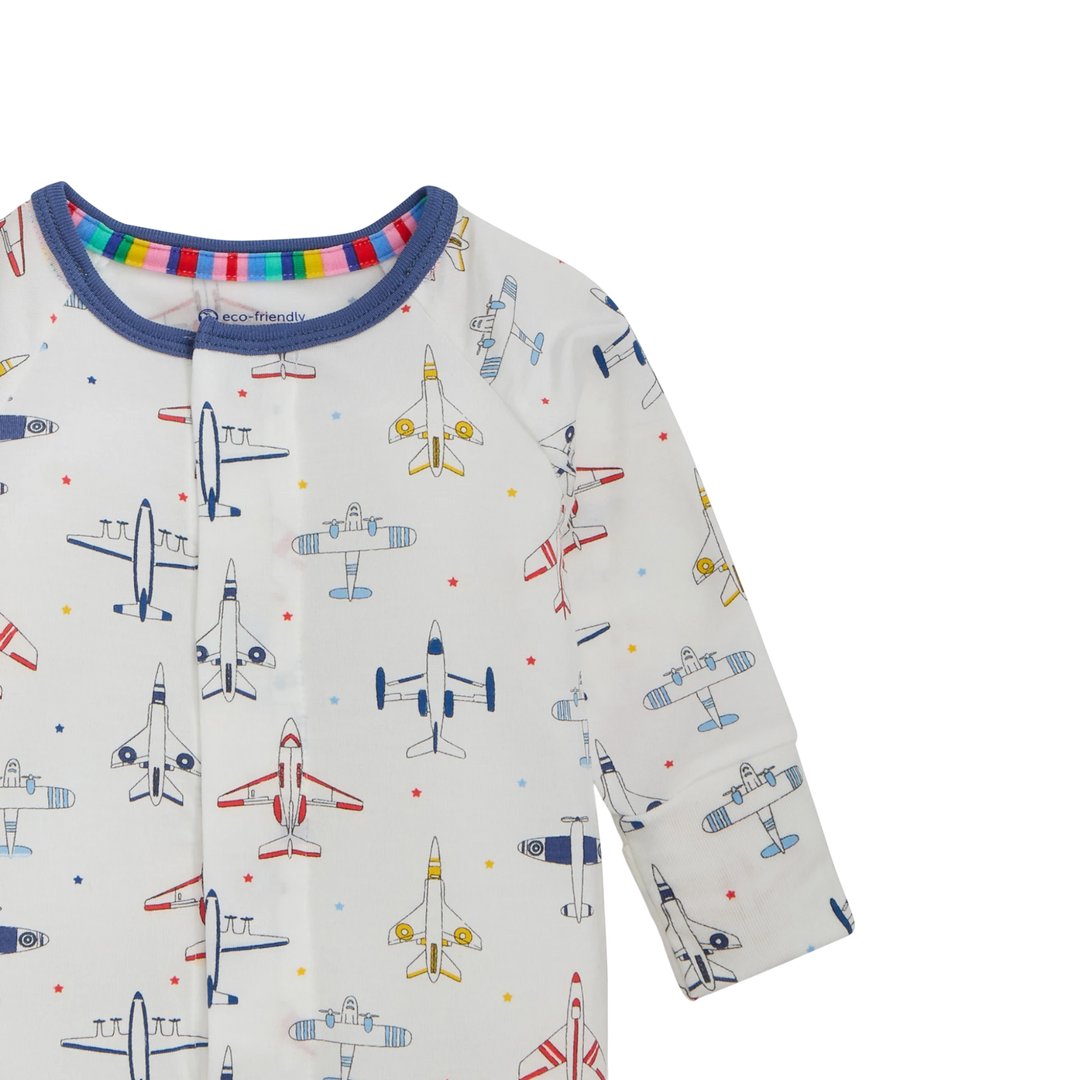 That Store modal convertible coverall in white with a colourful airplane print and blue trim on the neckline.