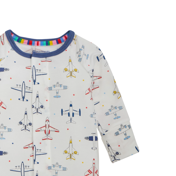 That Store modal convertible coverall in white with a colourful airplane print and blue trim on the neckline.