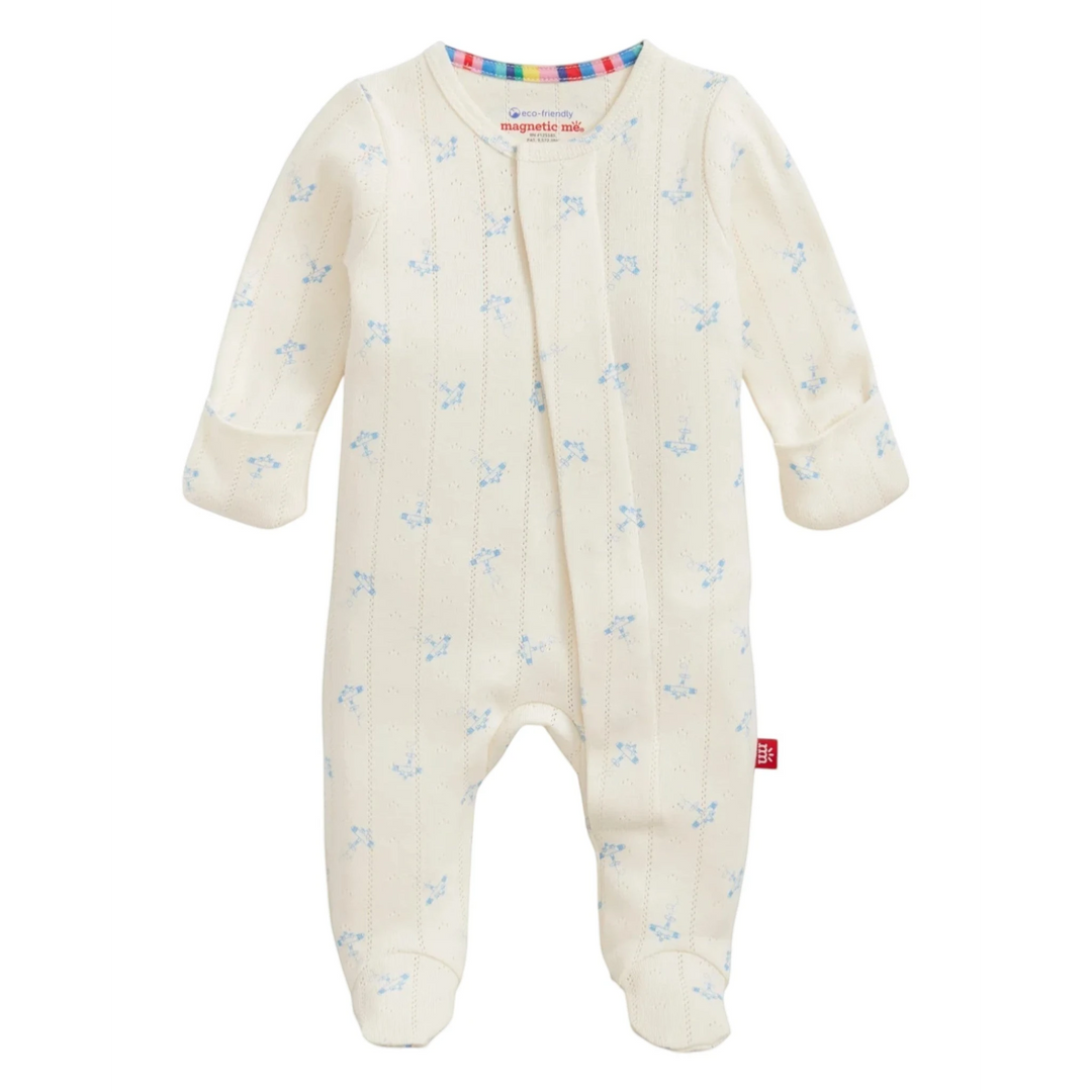 That Store organic cotton pointelle magnetic footie in cream with a blue airplane print and magnetic closures.