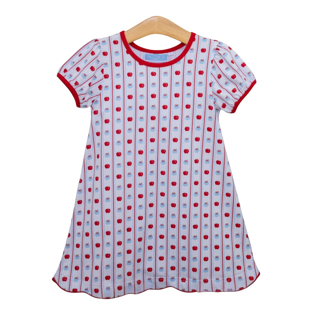 That Store girls cotton apple print dress with red trim and vertical stripes on a wooden hanger