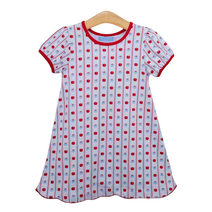 That Store girls cotton apple print dress with red trim and vertical stripes on a wooden hanger