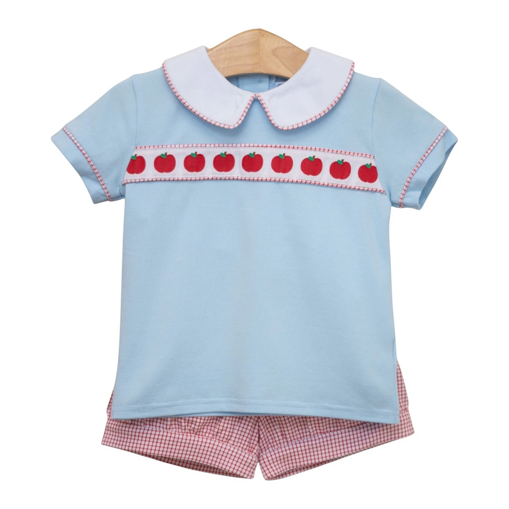 That Store boys short set in light blue cotton with apple ribbon trim, white collar, and red gingham shorts.