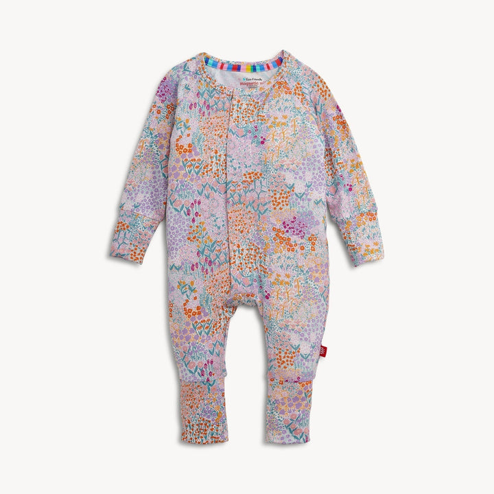 That Store Arabella modal convertible coverall in a colorful floral print with magnetic closures and foldover cuffs.