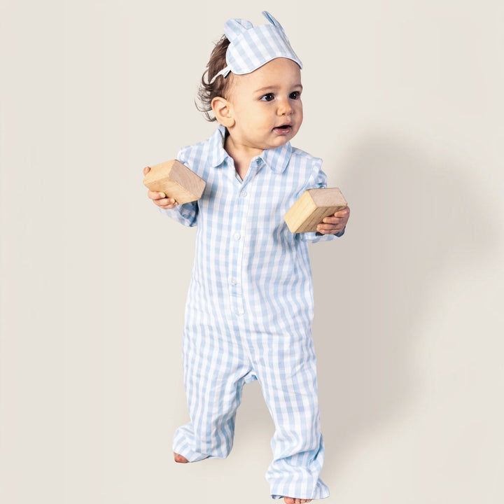 That Store baby romper in light blue gingham brushed cotton with a matching sleep mask and wooden blocks