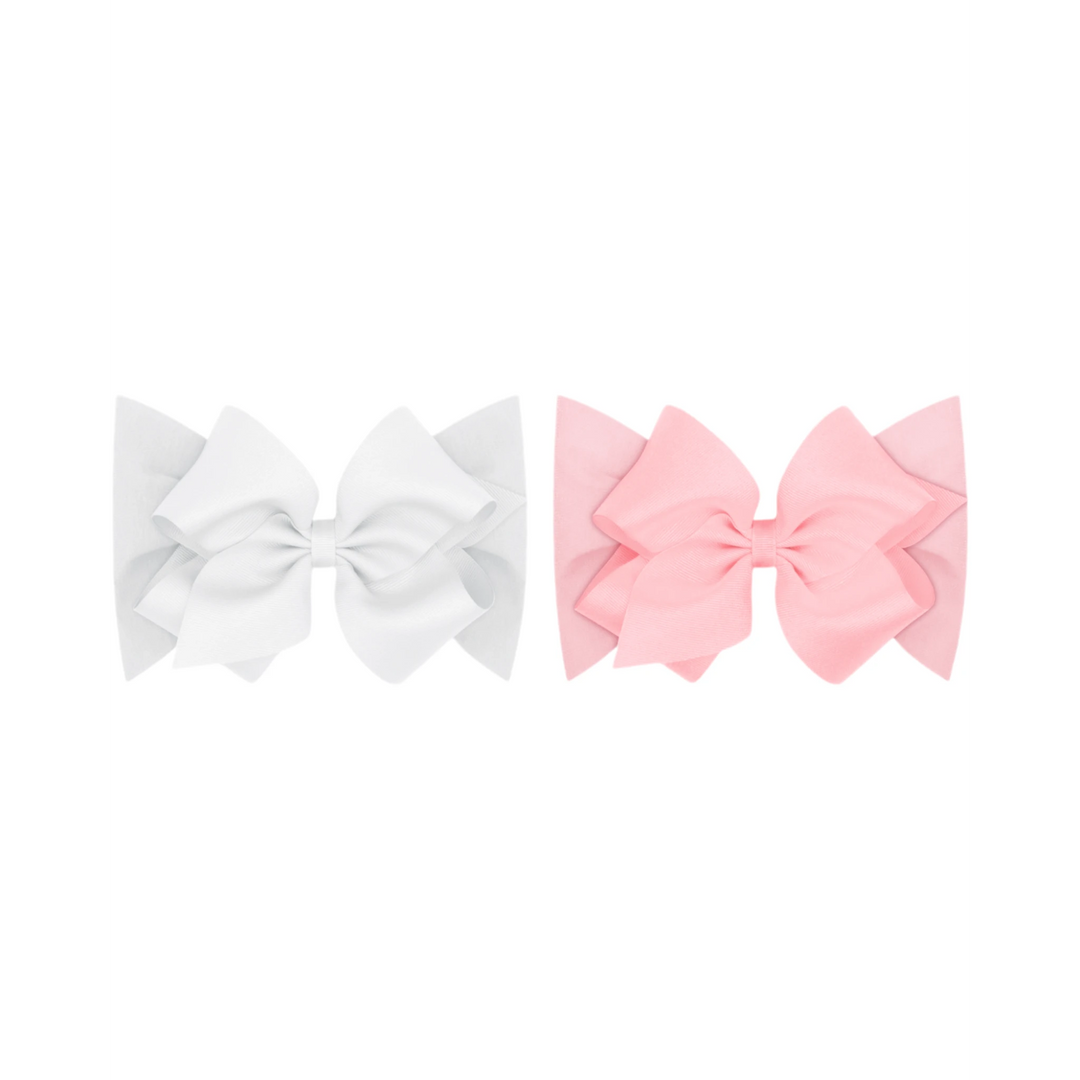 That Store baby headbands featuring white and pink grosgrain bows on soft cotton jersey bands for infants.