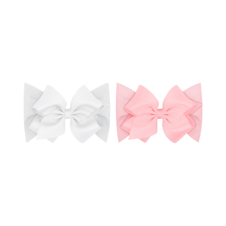 That Store baby headbands featuring white and pink grosgrain bows on soft cotton jersey bands for infants.