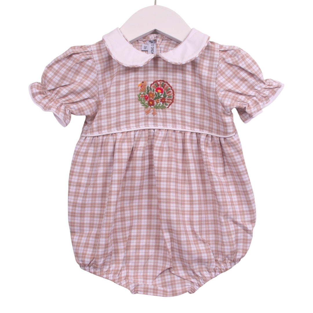 That Store beige plaid girls bubble with turkey embroidery, Peter Pan collar, and puff sleeves for Thanksgiving.