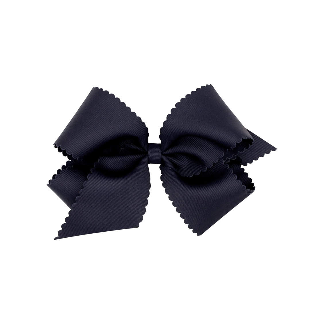 That Store black grosgrain hair bow for girls featuring a decorative scalloped edge and a secure clip