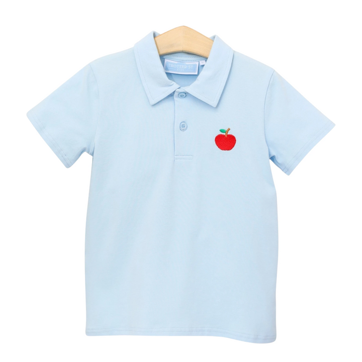 That Store light blue boys polo shirt with a red apple embroidery on the chest, made from cotton and spandex blend.