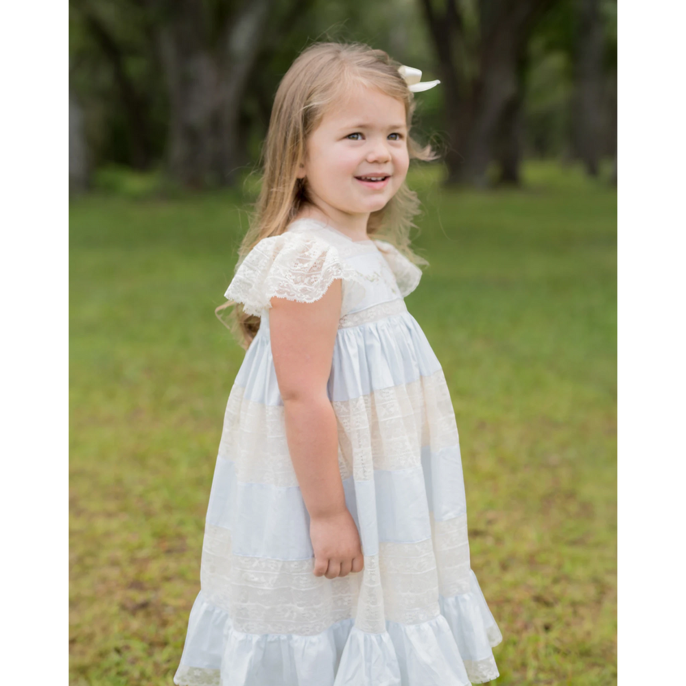That Store Mary Frances blue and ecru cotton heirloom dress with intricate lace detailing worn by a young girl.