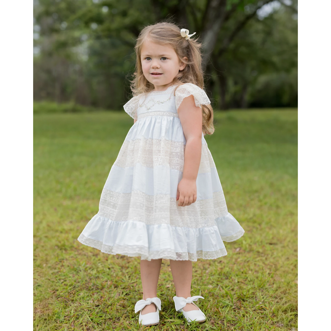 That Store Mary Frances ecru and blue cotton heirloom dress with intricate lace and floral embroidery on a young girl