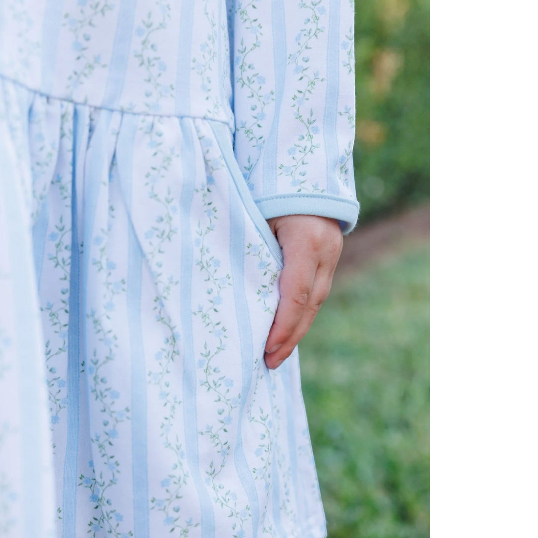 That Store blue floral drop waist dress with striped pattern and side pocket on a young girl