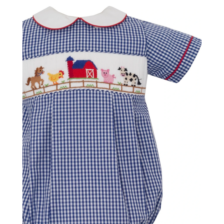That Store boys bubble in blue gingham with hand-smocked farm animal embroidery and a white Peter Pan collar.