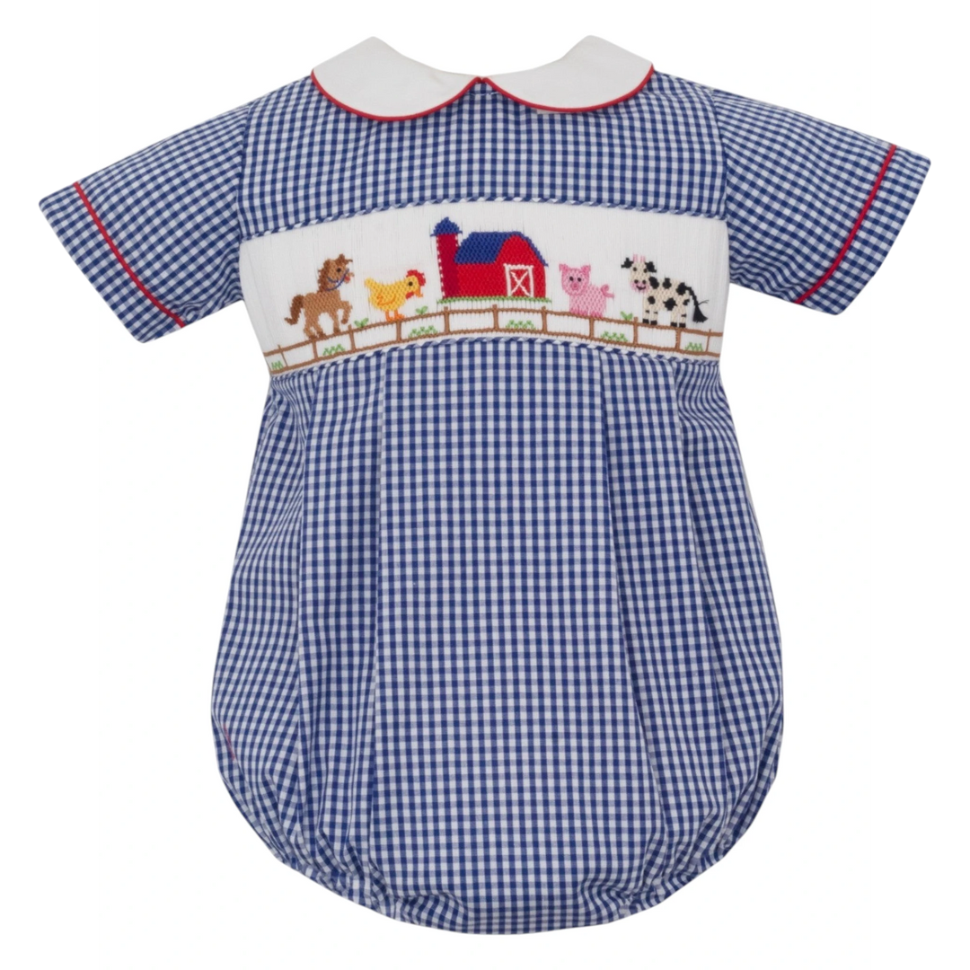 That Store blue gingham boys bubble with hand-smocked farm animal embroidery and a white Peter Pan collar.