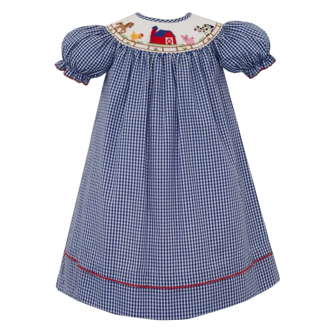 That Store blue gingham bishop dress with farm animal smocking, puff sleeves, and red trim detail.