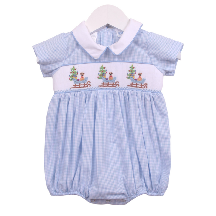 That Store boys blue gingham bubble featuring smocked puppy in a sleigh design with a white peter pan collar