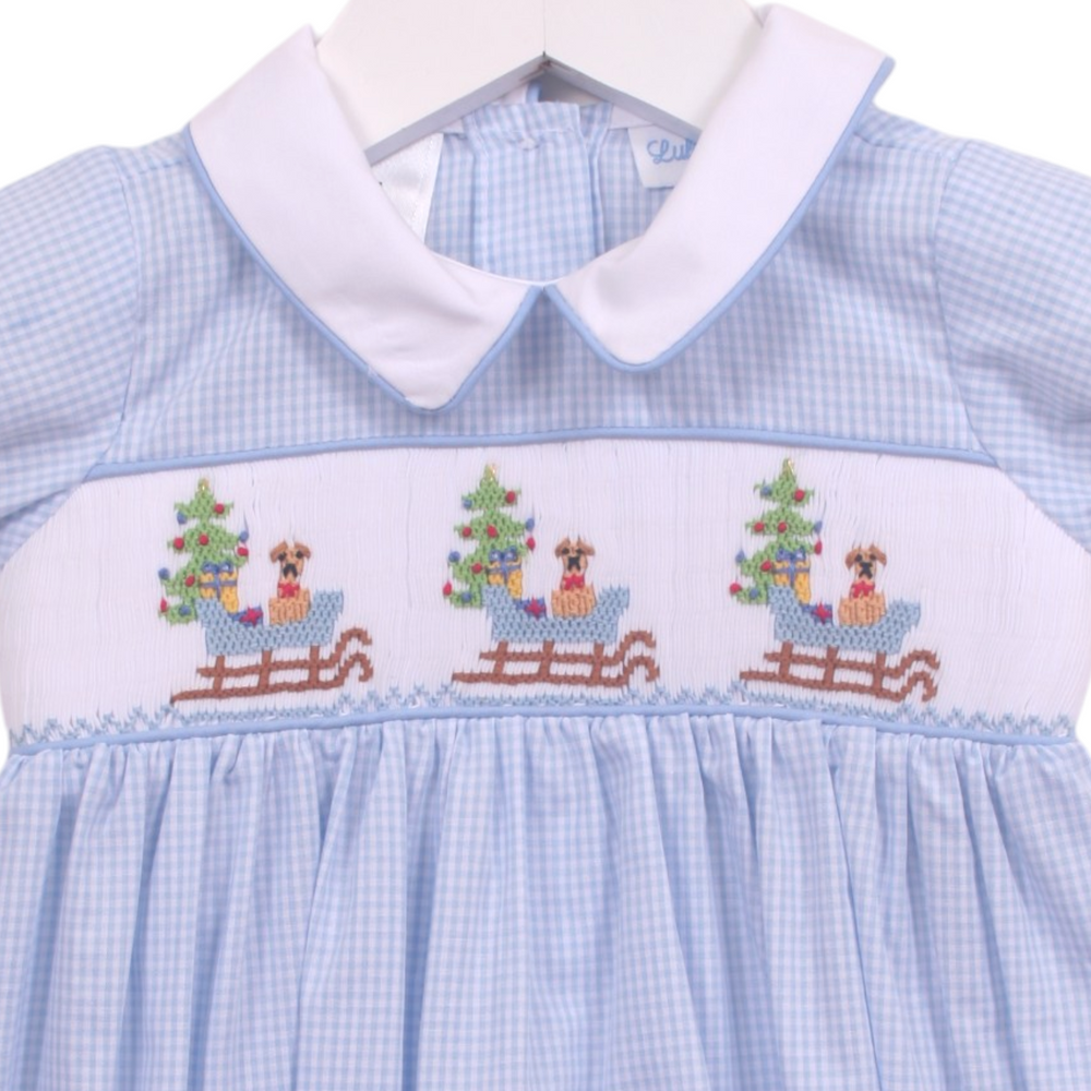 That Store boys blue gingham bubble featuring smocked puppy in a sleigh design and a white peter pan collar