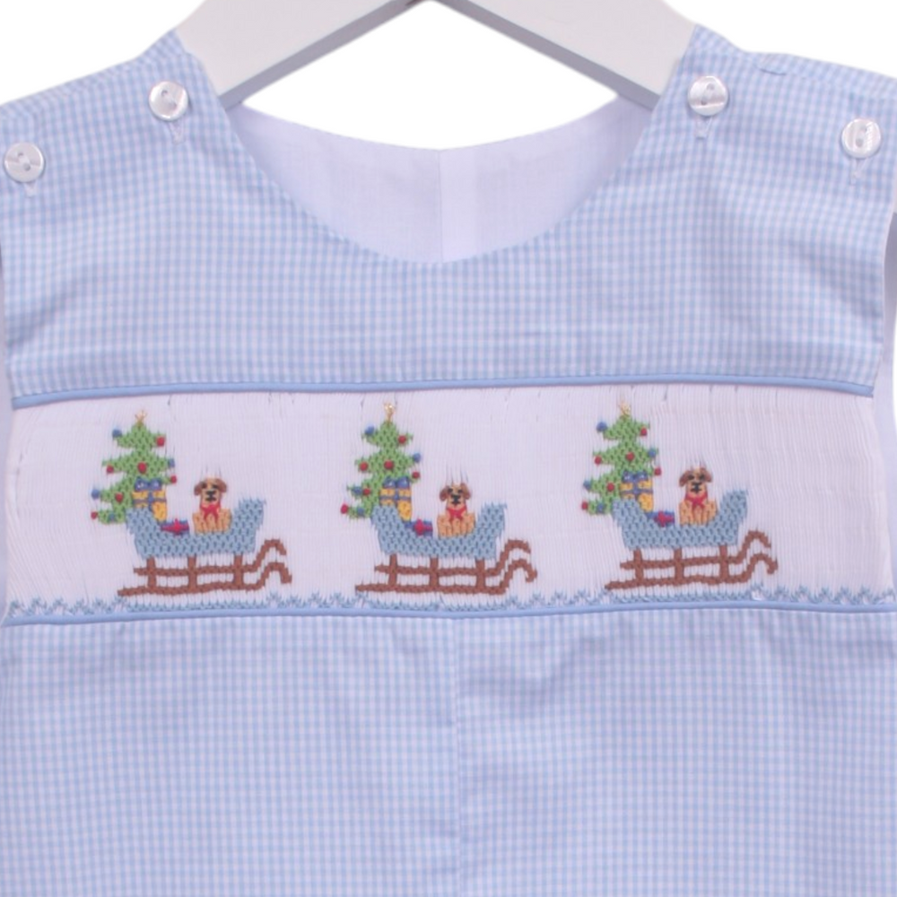 That Store boys blue gingham shortall featuring smocked puppy in a sleigh and Christmas tree holiday embroidery