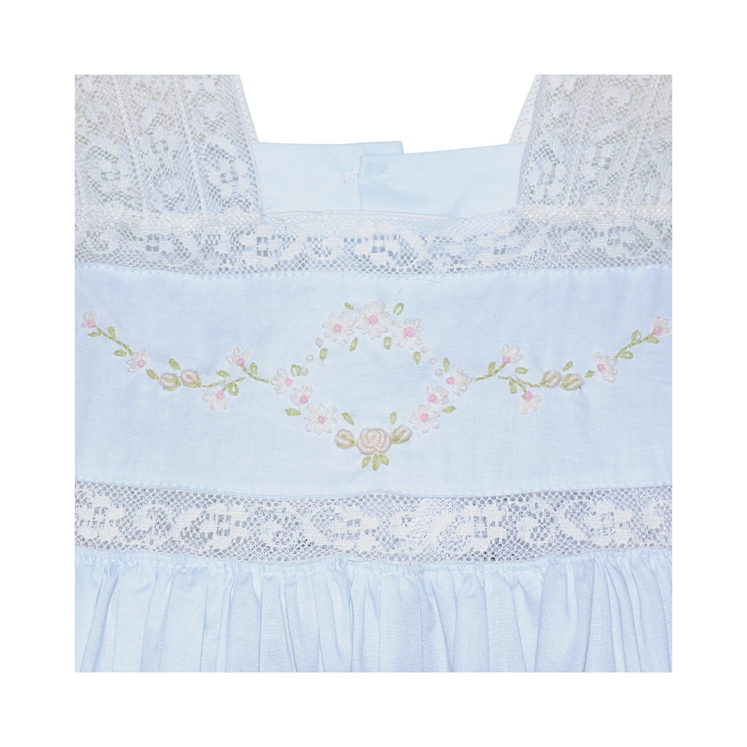 That Store blue cotton heirloom dress featuring intricate white lace trim and delicate floral embroidery details.