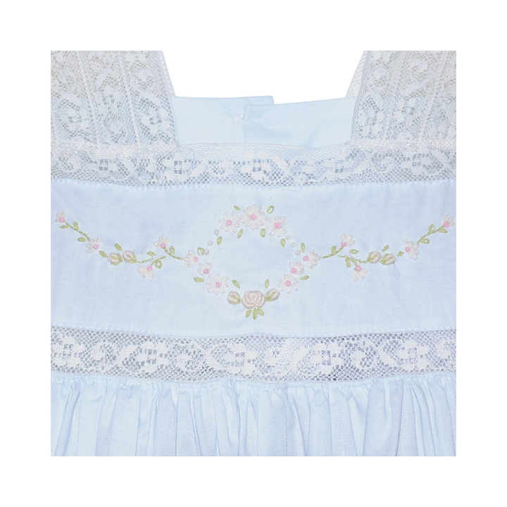 That Store blue cotton heirloom dress featuring intricate white lace trim and delicate floral embroidery details.