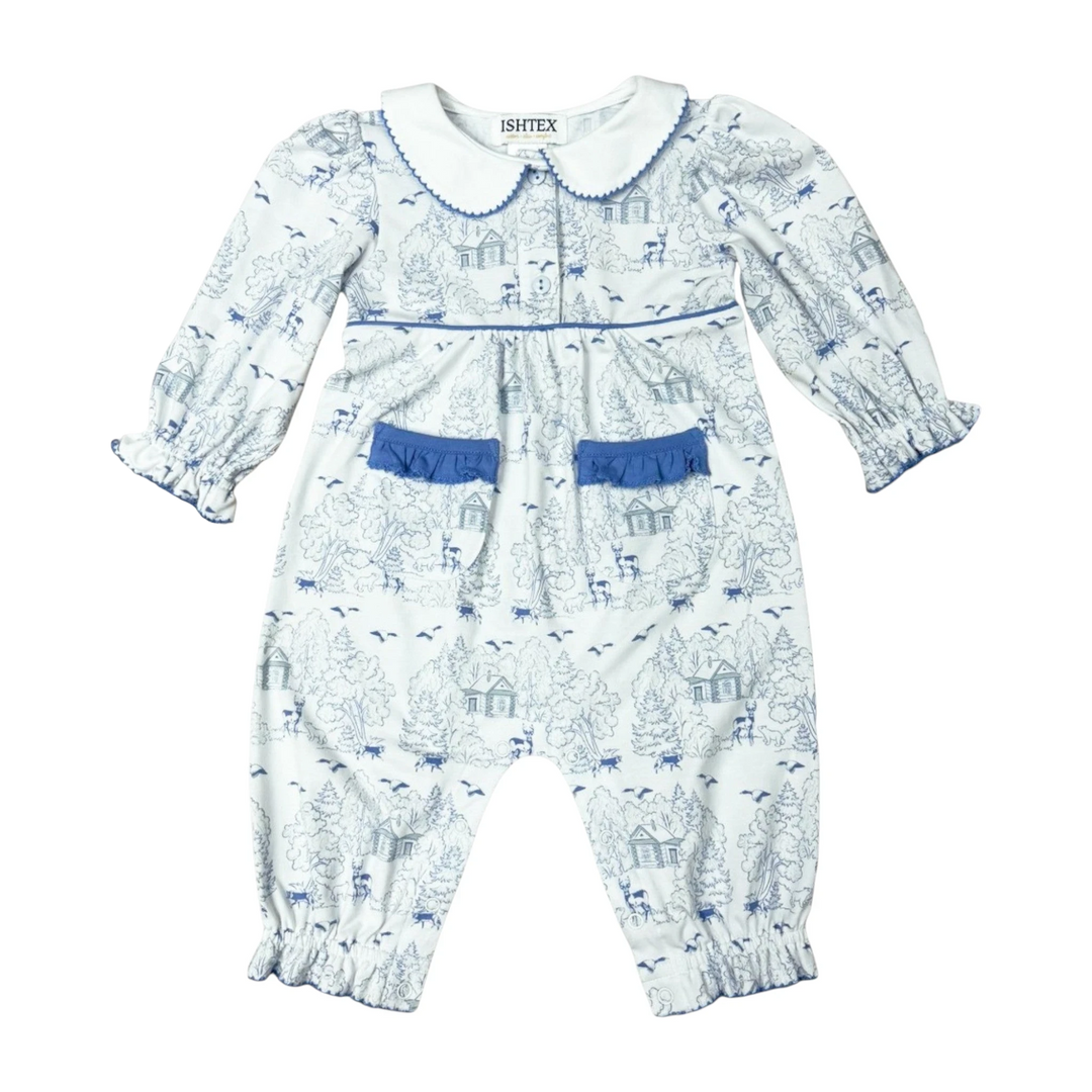 That Store girls romper in white with blue log cabin and forest print, featuring a peter pan collar and ruffle pockets