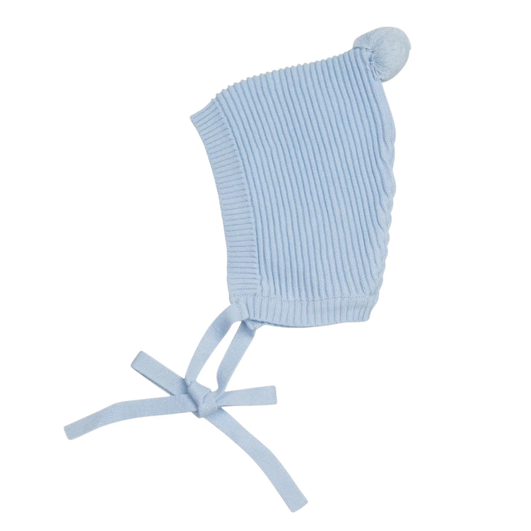 That Store baby bonnet in light blue ribbed knit with a top pompom and tie chin straps.
