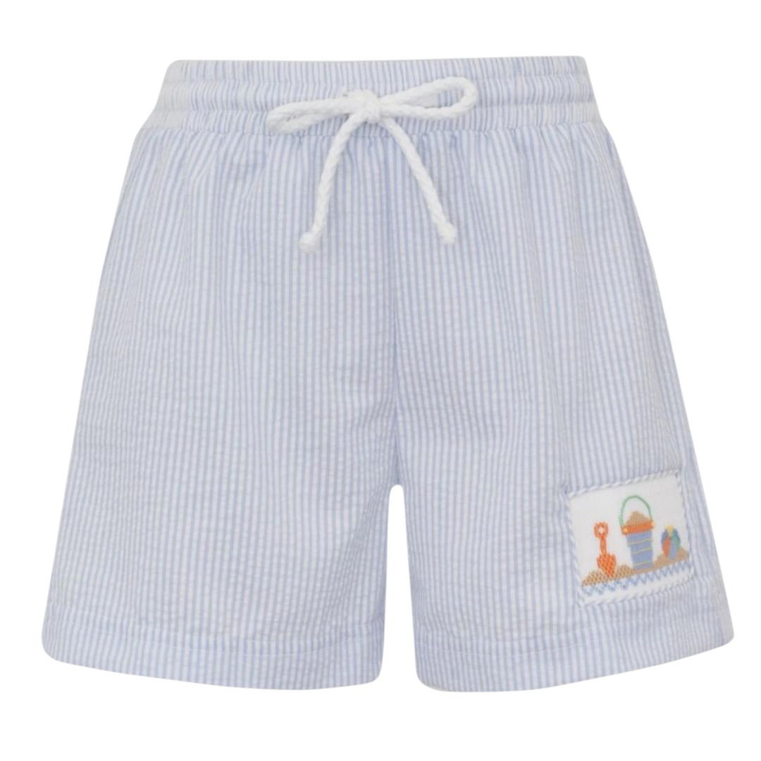 That Store blue seersucker boy's swim trunks with smocked sand pail and beach ball embroidery and white drawstring