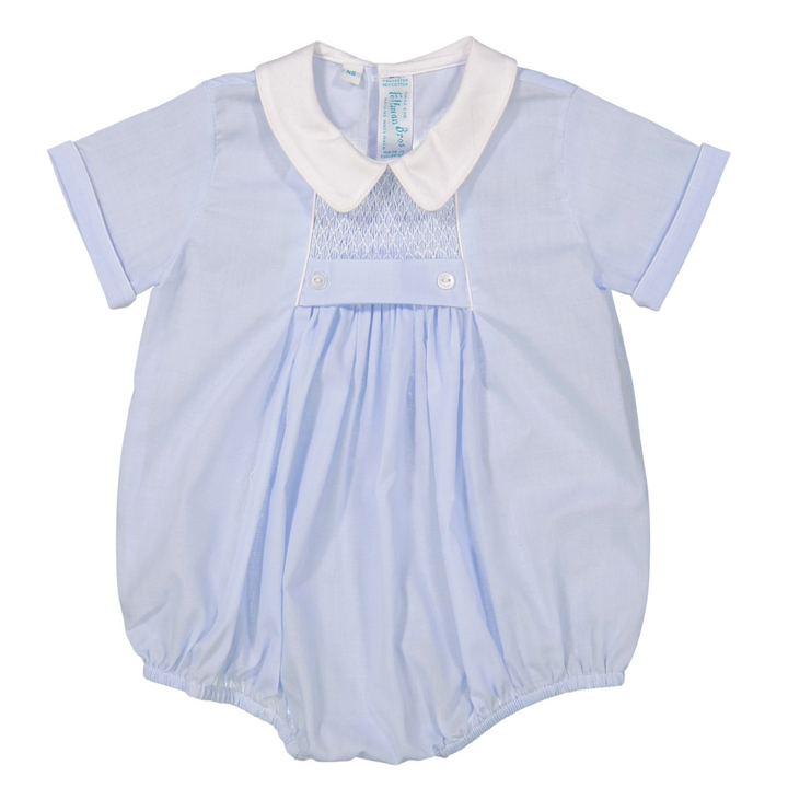 That Store baby boy blue creeper with white pique collar, hand-smocked chevron detail, and tuxedo-style buttons.