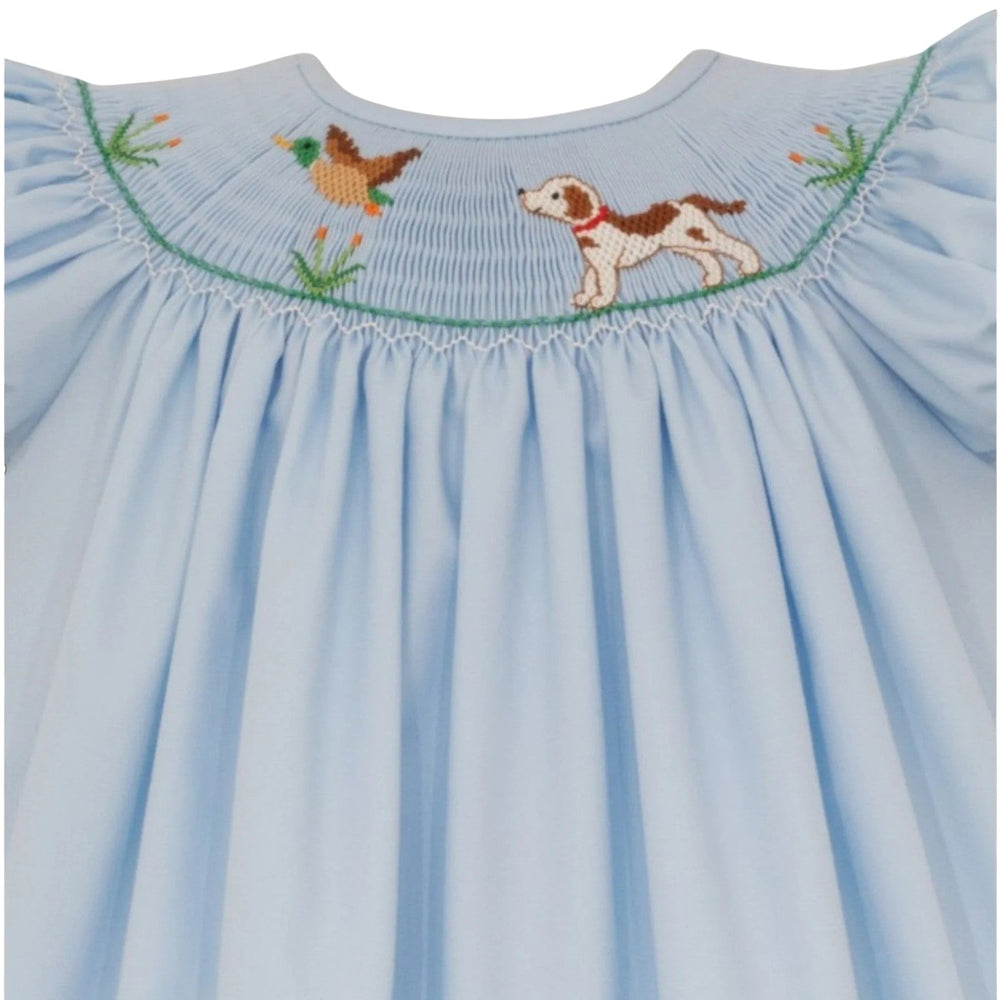 That Store light blue bishop dress with hand-smocked hunting dog and mallard embroidery and green sleeve trim.