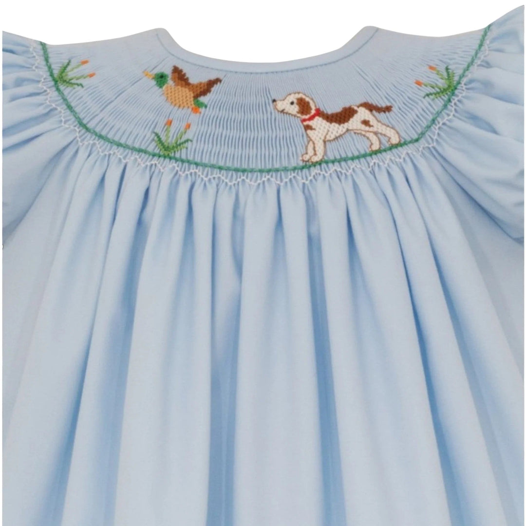 That Store light blue bishop dress with hand-smocked hunting dog and mallard embroidery and green sleeve trim.