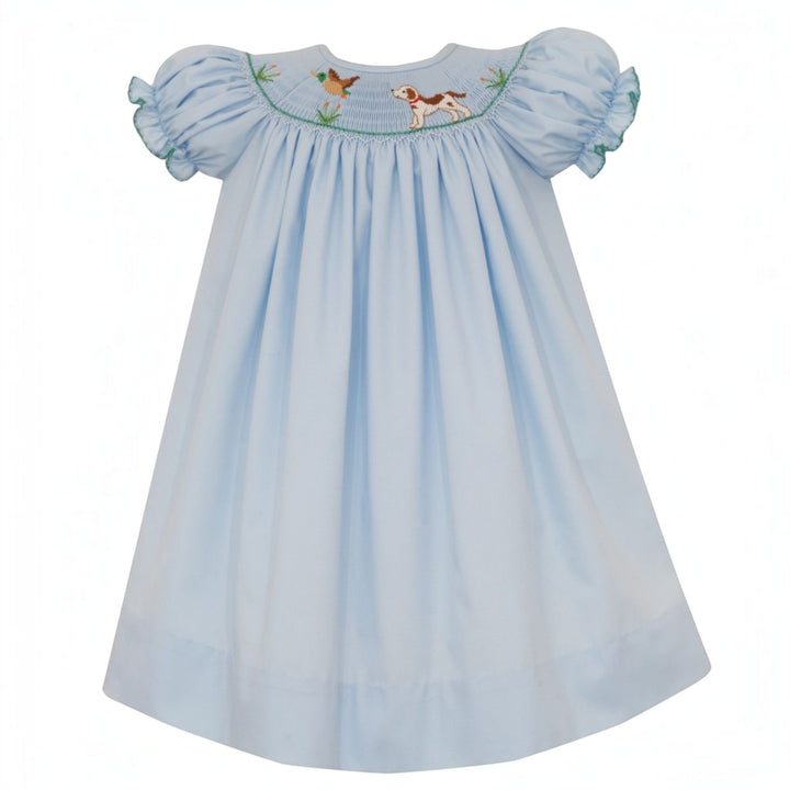 That Store blue smocked bishop dress for girls featuring hunting dog and mallard embroidery and green puff sleeves.