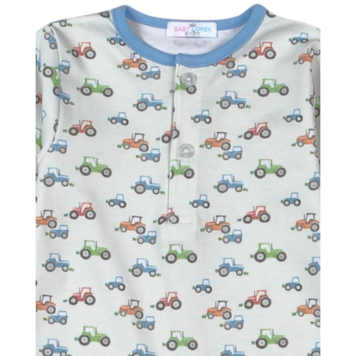 That Store boys romper in blue Pima cotton with a colorful tractor print and a button-front neckline