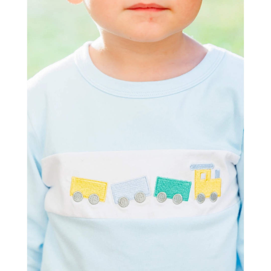 That Store boys light blue long-sleeve shirt with a white chest panel featuring a colorful embroidered train motif.