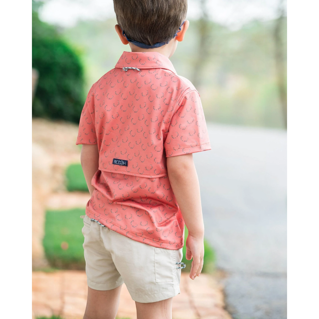 That Store boys performance polo in crabapple with antler print, featuring a vented back and signature loop.