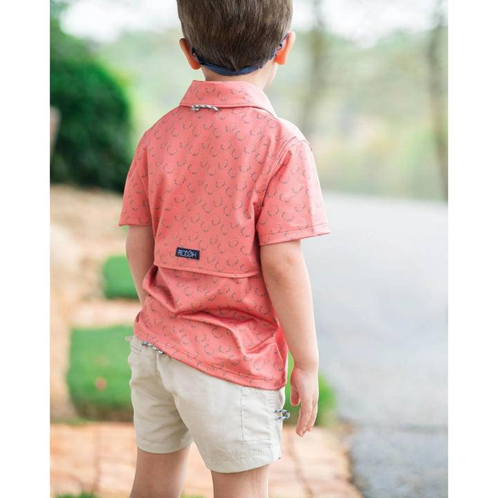 That Store boys performance polo in crabapple with antler print, featuring a vented back and signature loop.