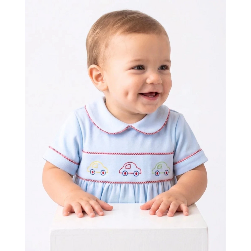 That Store baby boy bubble in Bluffton Blue knit featuring red trim and embroidered colorful cars on the chest