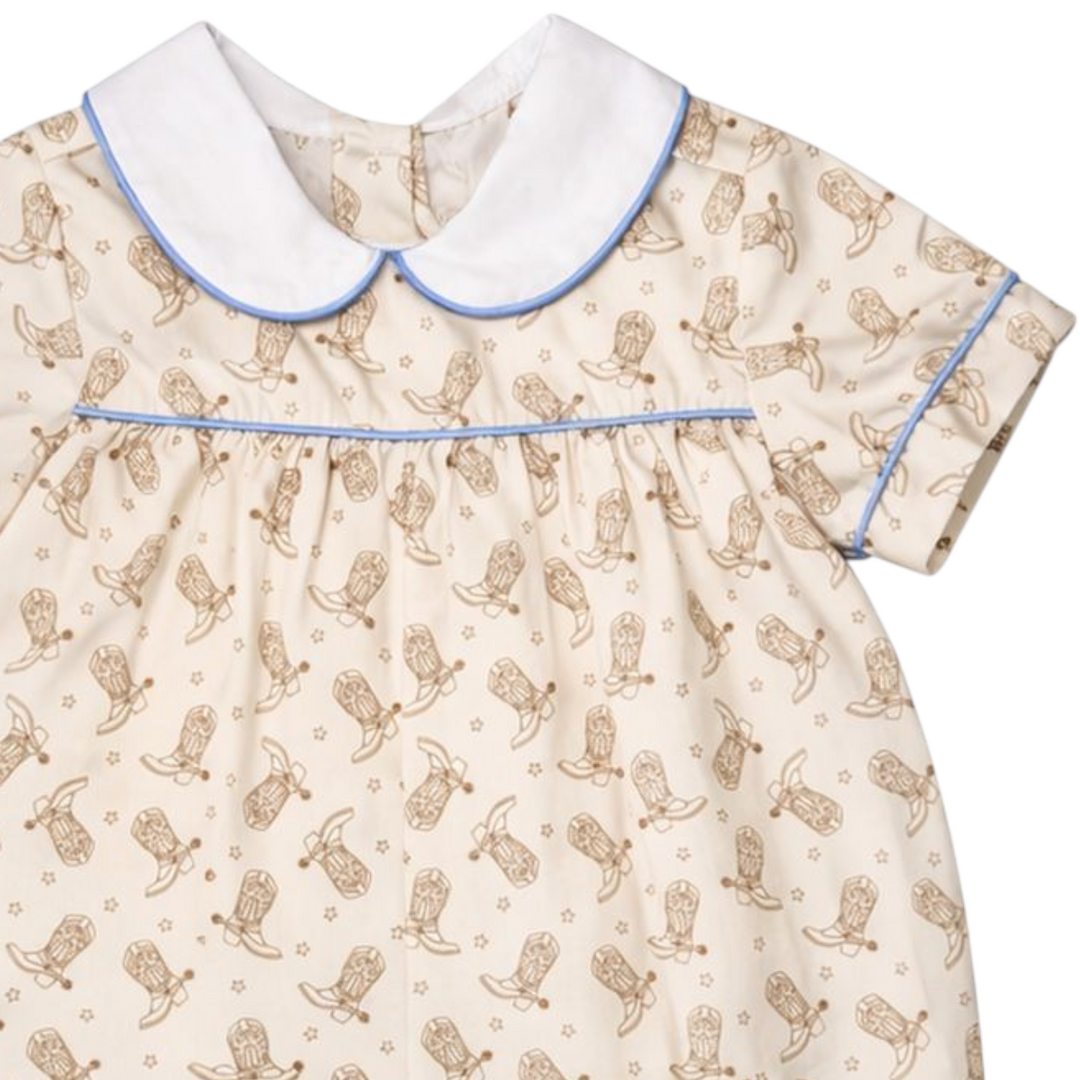 That Store boys bubble in brown with a cowboy boot print, white peter pan collar, and blue piping detail.