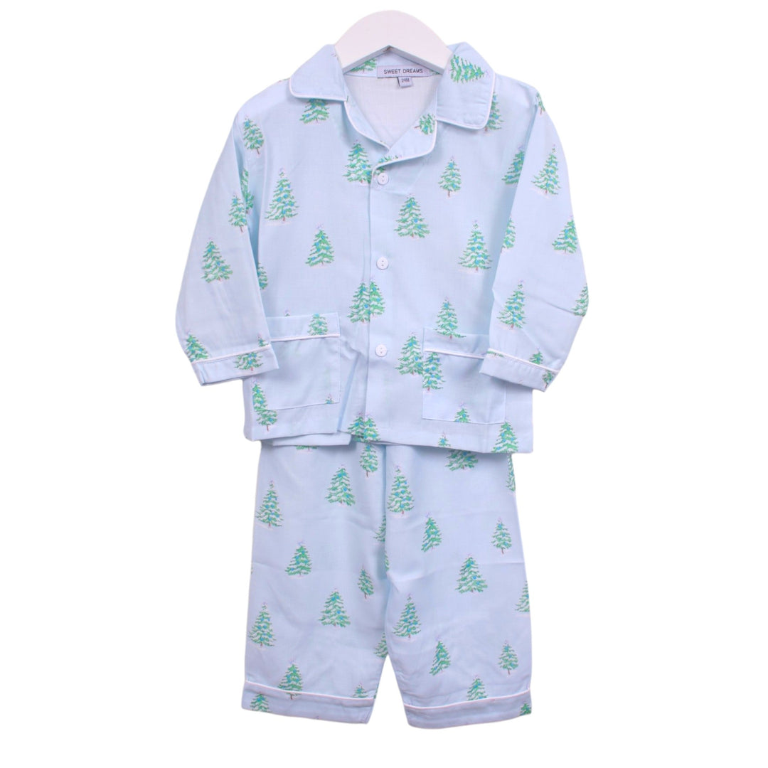 That Store boys light blue pajama set with green Christmas tree print, button-down top, and white piping detail.