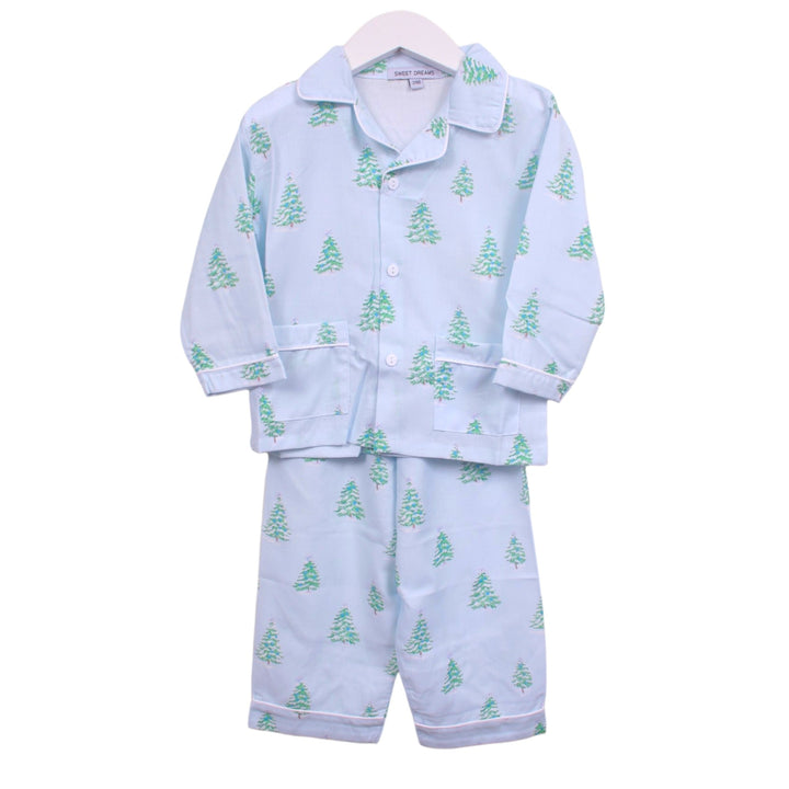 That Store boys light blue pajama set with green Christmas tree print, button-down top, and white piping detail.