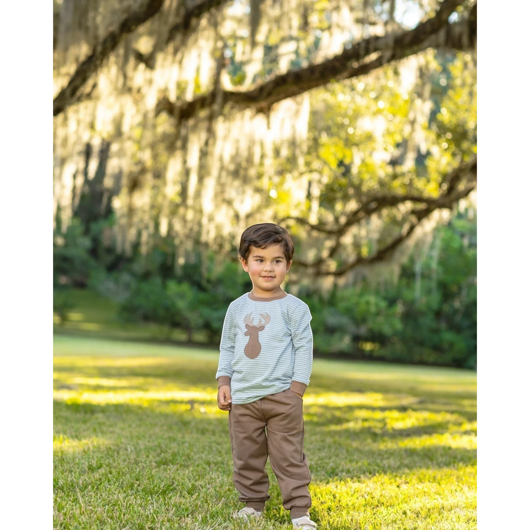 That Store boys jogger set with green striped long sleeve deer applique shirt and brown pants in a park setting