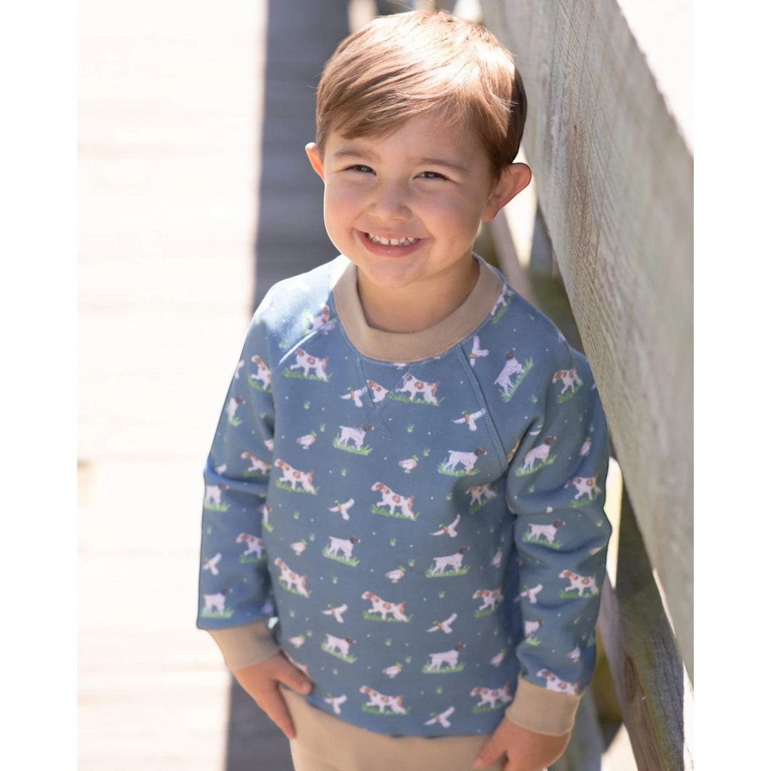 That Store boys green French terry sweatshirt featuring a playful dog and duck print with tan ribbed trim