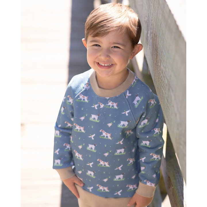 That Store boys green French terry sweatshirt featuring a playful dog and duck print with tan ribbed trim